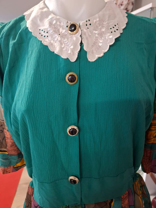 70's-80's Elbow puff sleeves. Embroidered design of the collar. Round neck. complete buttons down. Non stretch. Pleated skirts. Multi color design.