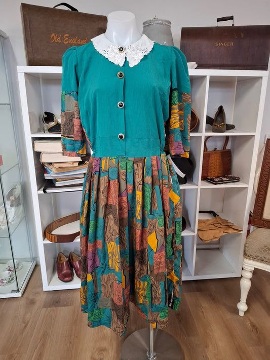 70's-80's Elbow puff sleeves. Embroidered design of the collar. Round neck. complete buttons down. Non stretch. Pleated skirts. Multi color design.