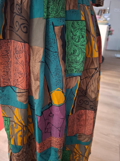 70's-80's Elbow puff sleeves. Embroidered design of the collar. Round neck. complete buttons down. Non stretch. Pleated skirts. Multi color design.