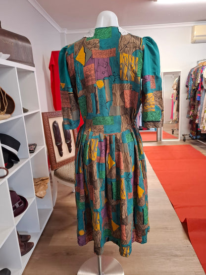 70's-80's Elbow puff sleeves. Embroidered design of the collar. Round neck. complete buttons down. Non stretch. Pleated skirts. Multi color design.