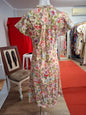 Jassie 70's to 80's Short sleeves V-neck with zipper in front. Non-stretch and below the knee level.