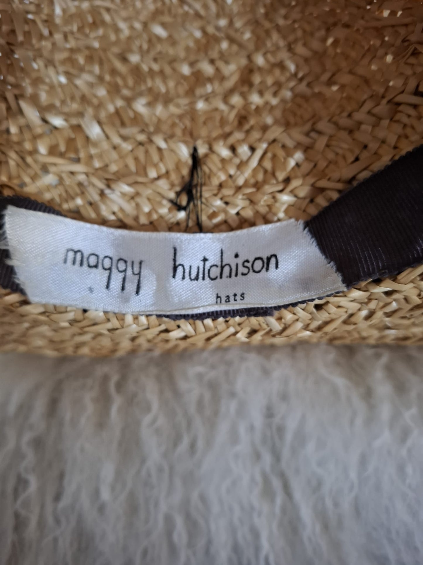 Maggy Hutchison  Sun Kissed and Timeless-A wide-brimmed straw hat with a touch of contrast — finished with a black velvet ribbon for effortless elegance.