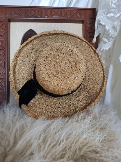 Maggy Hutchison  Sun Kissed and Timeless-A wide-brimmed straw hat with a touch of contrast — finished with a black velvet ribbon for effortless elegance.